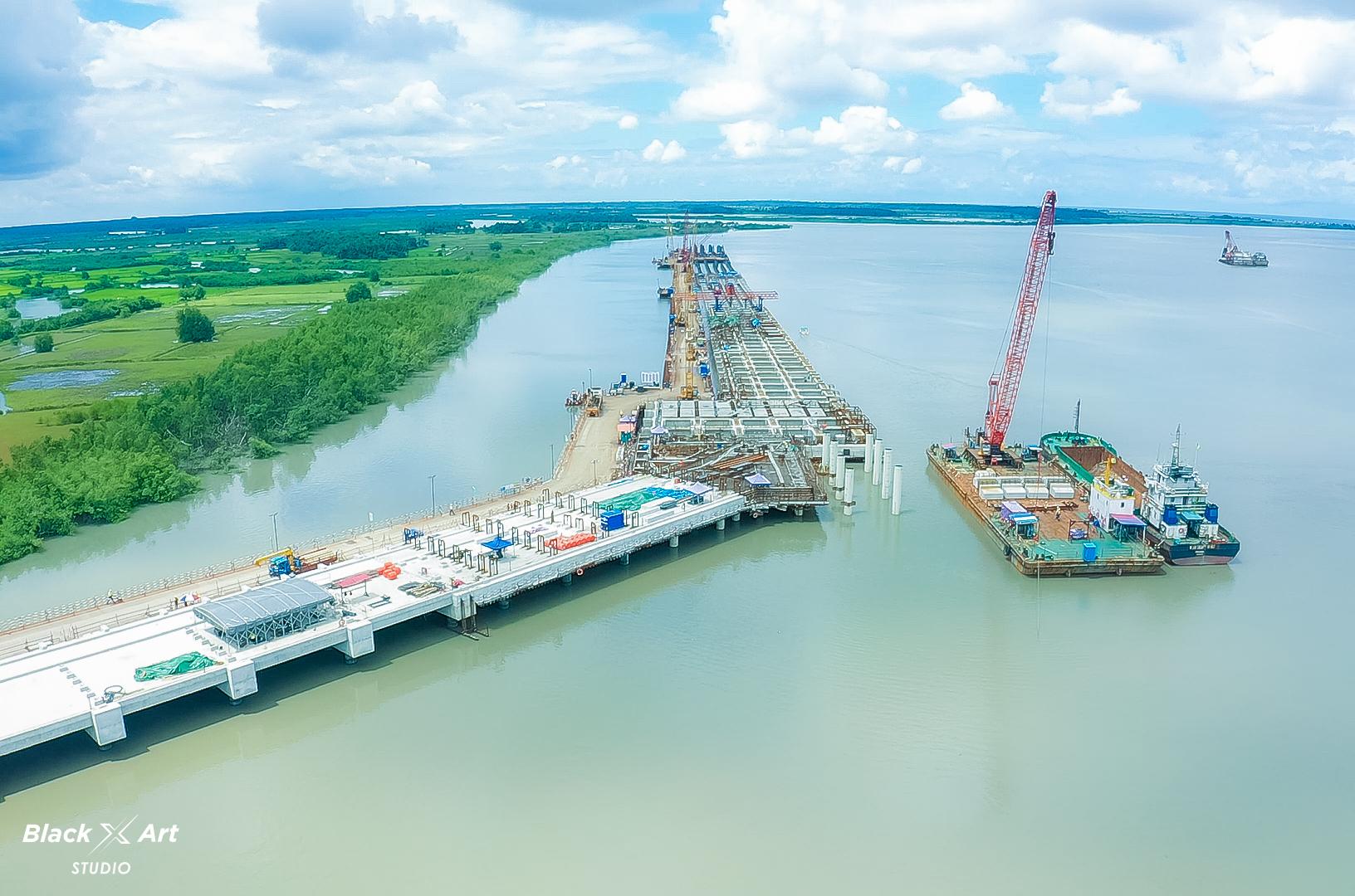 Aerial view of infrastructure and bridge construction over a river in Conakry.